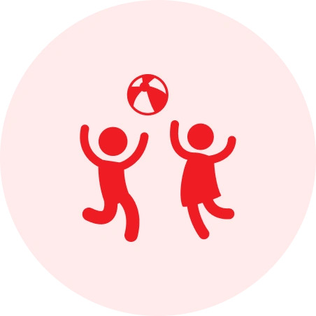 Two kids playing with a beach ball.