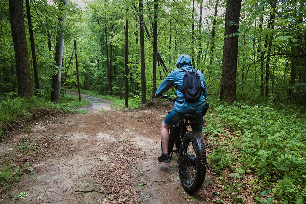 Person riding an e-bike on a trail.