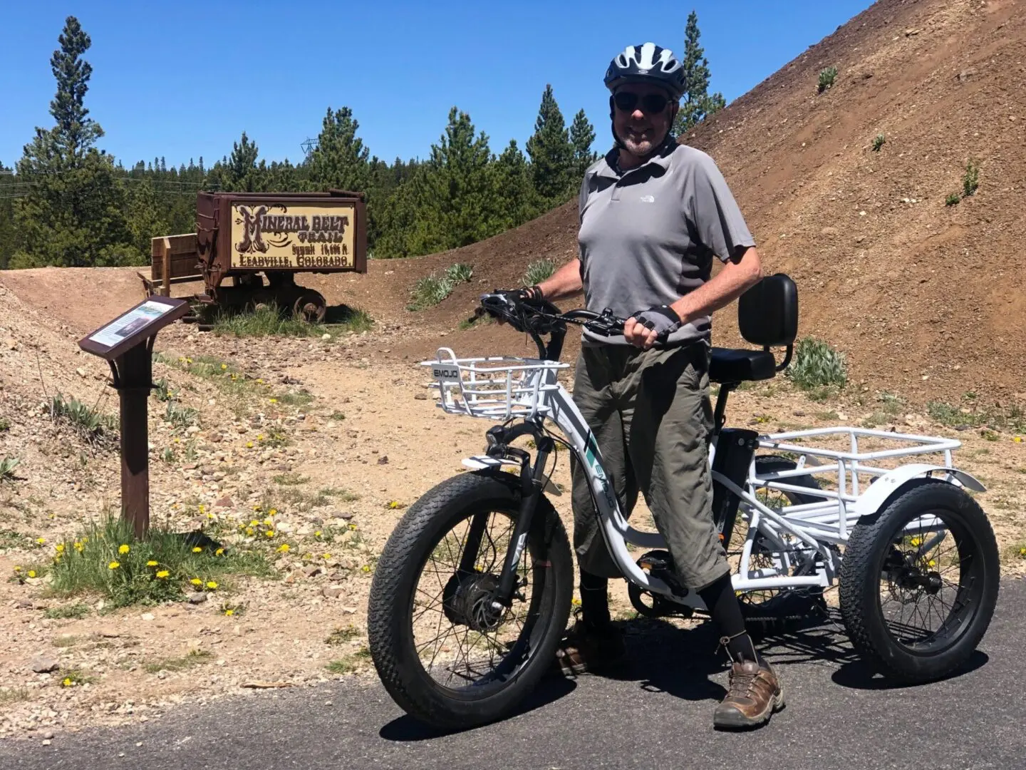 A man standing next to an electric bike.