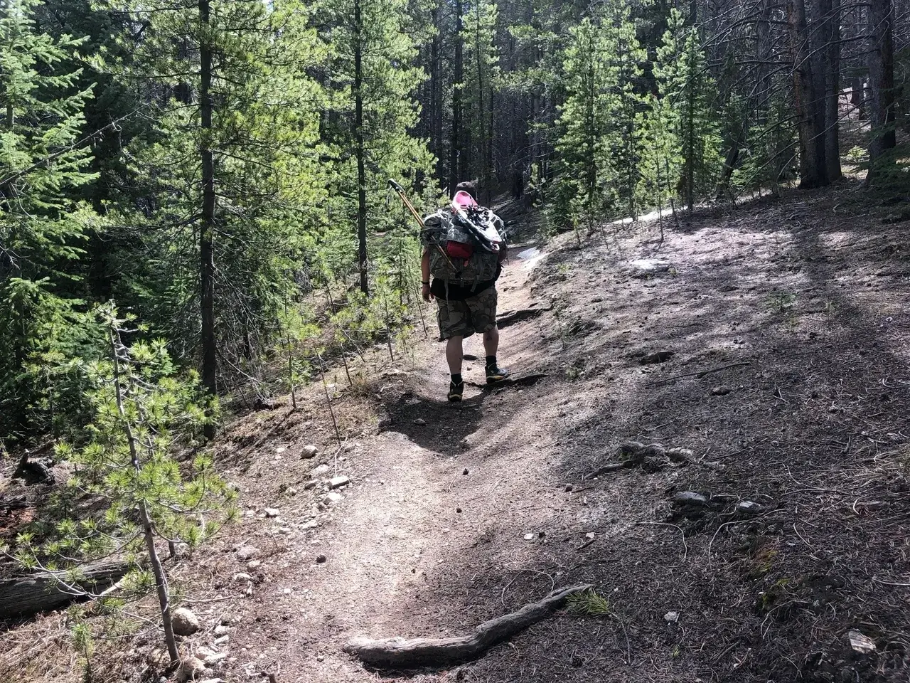 A man walking up the side of a mountain