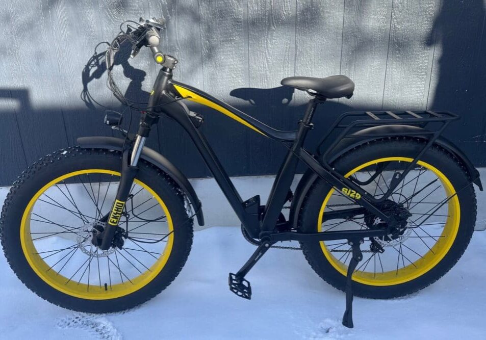 Black and yellow fat tire bicycle on snow.