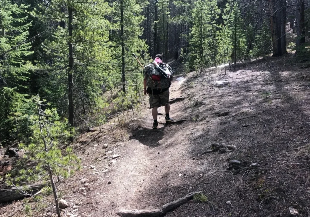 A man walking up the side of a mountain